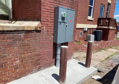 A newly built electrical panel on the outside of a brick building