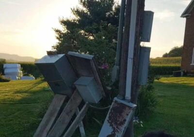 Before image of multiple electrical boxes, toppling over